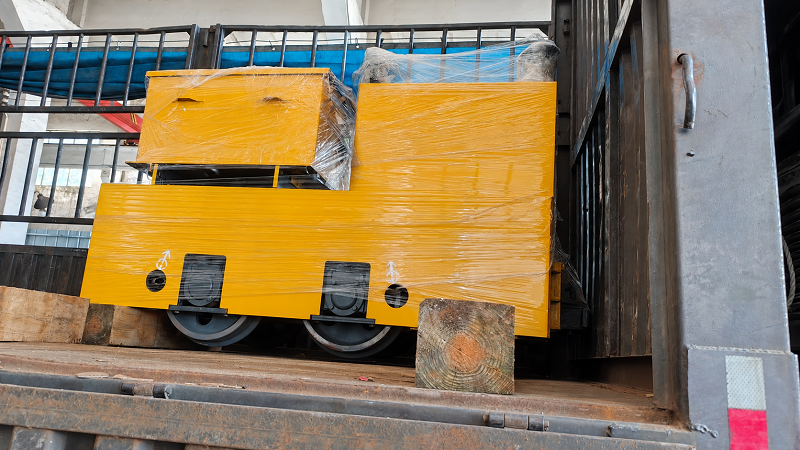 A wrapped locomotive on the truck bed